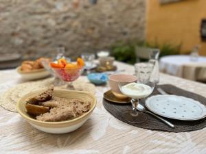 a table with a bowl of food on a table at Le Paillé de Torreilles in Torreilles