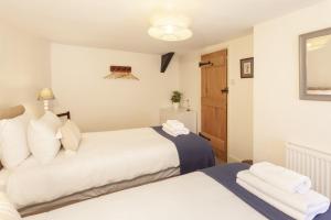 Voodi või voodid majutusasutuse Pebble Cottage, Dunster toas