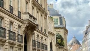 a group of buildings on a city street at Le Grand Hôtel Cayré in Paris
