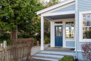 a house with a blue door and a fence at Endless Summer by Seabrook Hospitality in Pacific Beach
