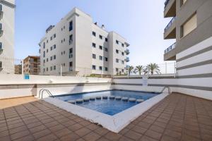 a swimming pool in the middle of a building at Beach Apartment in Calafell in Calafell