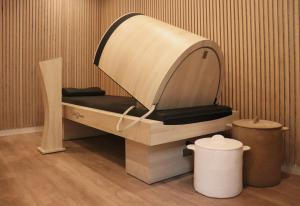 a chair in a room with a bucket and a trash can at Hotel Litteraire Le Swann, BW Premier Collection in Paris