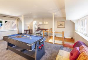 a living room with a pool table in it at Coach House View, Porlock Weir in Porlock