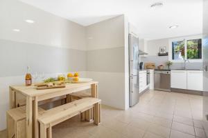 a kitchen with a table with fruit on it at Villa Pepponi in Sant Lluis +31 photos