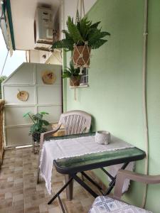 una camera verde con un tavolo e due sedie di Studio Anlia a Nea Makri
