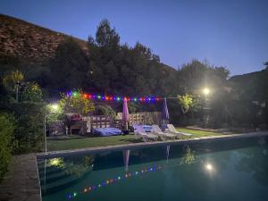 a backyard with a swimming pool at night at Cortijo Loma del Estanque in Monachil