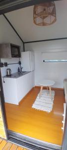 a small kitchen with a table and a sink at Cantal Tiny Houses in Salta +22 photos