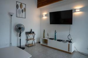 a living room with a flat screen tv on a wall at Résidence ATLAS in Saint-Laurent du Maroni