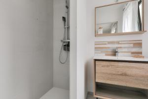 a bathroom with a sink and a mirror at Maison pour 8 - 300m de la plage du Rouvran in Le Tour-du-Parc +16 photos