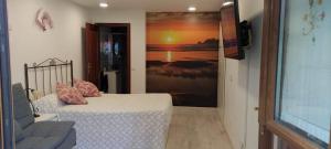 a bedroom with a bed and a painting on the wall at Apartamento Mar de Fora in Finisterre