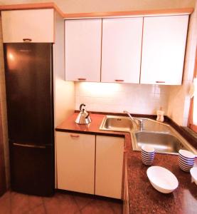 a kitchen with a refrigerator and a sink at Casa del Carmine in Anghiari +84 photos