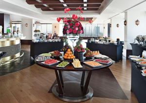 a buffet of food on a table in a restaurant at Park Regis Kris Kin Hotel in Dubai
