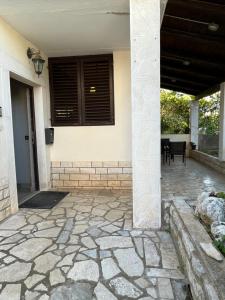 a porch of a house with a stone patio at Seashell apartment in Vrsar +1 photo