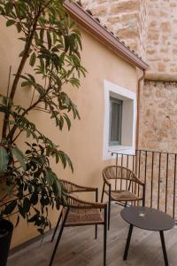 a balcony with two chairs and a table at Pou by Seaward Suites Only Adults in Villajoyosa