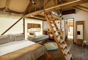 a bedroom with a loft bed and a ladder at Ergon Beach House Nikiti in Nikiti
