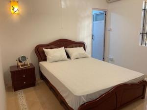 a bedroom with a large bed with a wooden headboard at Apartment with exceptional sea view in Trou aux Biches
