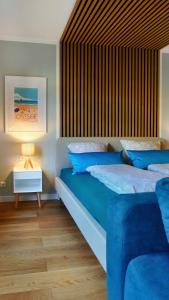 a bedroom with two beds with blue pillows at Strand11 Hochwertige Ferienwohnungen Ahlbeck in Ahlbeck