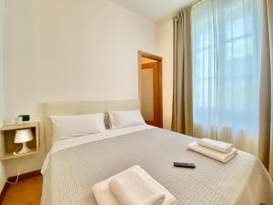 Łóżko lub łóżka w pokoju w obiekcie i portici del centro