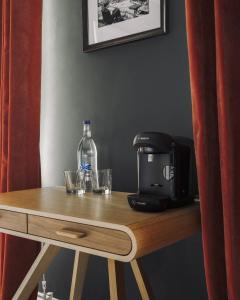 a table with a coffee maker and a bottle on it at The Porterhouse grill & rooms in Oxford