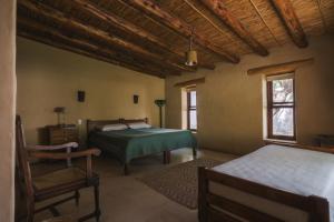 Postel nebo postele na pokoji v ubytování Aguaribay Tilcara