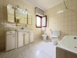 a bathroom with a toilet and a sink and a toilet istg at Casona de la Loma - 2806 in San Mamés de Meruelo +22 photos