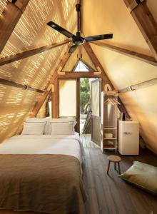 a bed in a room with a ceiling fan at Ergon Beach House Nikiti in Nikiti