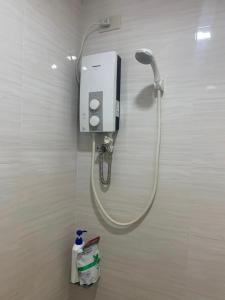 a shower head on a wall in a bathroom at Puerto Princesa City Palawan Harmony Inn in Puerto Princesa City