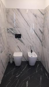 a bathroom with a white toilet and a sink at Villetta Gloria in Venice-Lido +21 photos