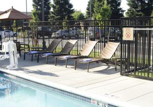 a group of chairs sitting next to a pool at TownePlace Suites Redding in Redding