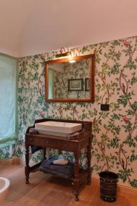 a bathroom with a tub and a mirror at Relais Scanno Green Home in Scanno +2 photos