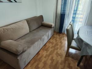 a living room with a couch and a table at Apartments Ivo in Njivice