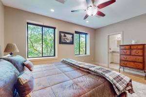 a bedroom with a ceiling fan and a dresser at Gloucester Harbor Hideaway in Gloucester