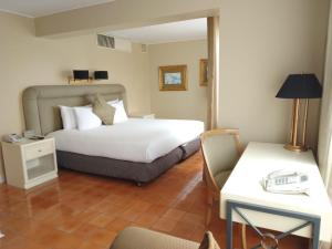 a hotel room with a bed and a table and chairs at Suites del Bosque Hotel in Lima +46 photos