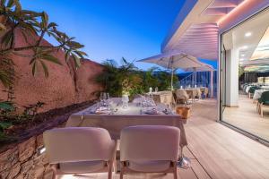 a dining room with a table and chairs at Grand Horizon Luxury Boutique Apartments in Puerto Rico de Gran Canaria