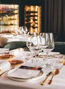 a table with wine glasses and plates and napkins at Grand Horizon Luxury Boutique Apartments in Puerto Rico de Gran Canaria