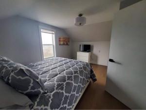 a bedroom with a bed and a window at The Cabot Suite in Chéticamp