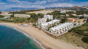an aerial view of a beach and buildings at Macdonald Leila Playa Resort in La Cala de Mijas
