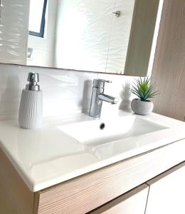 a bathroom with a white sink and a mirror at Casa Pátio country house in Enxara do Bispo +63 photos