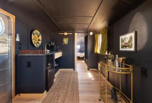 a hallway with blue walls and a kitchen with a counter at Acres Landing in Desert Hot Springs