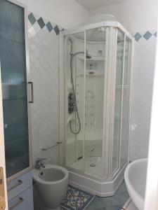 a bathroom with a shower and a toilet and a sink at Da Masciu in La Maddalena +10 photos