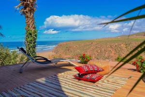 a picnic table with a view of the beach at Ocean View 6 bed Villa and Pool in Mirleft +82 photos