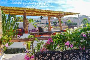 a garden with a pergola and some flowers at Ocean View 6 bed Villa and Pool in Mirleft