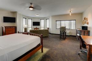 a bedroom with a bed and a desk and a couch at Stoney Creek Hotel Kansas City - Independence in Independence