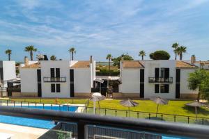 a view of a house from a balcony with a swimming pool at ¡Las Brisas en Conchas del Rompido! - El Rompido in El Rompido