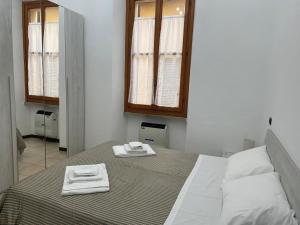 Ένα ή περισσότερα κρεβάτια σε δωμάτιο στο Ospitaci - Via Pertichetti