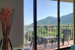 a view of a balcony with a table and chairs at The Refuge#3 Lovely 2 BR-Apt pool & good vibes in Santa Marta