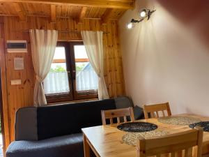 a living room with a couch and a table at DOMEK W ZACISZU Dębina in Debina