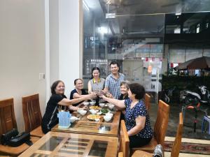 a group of people sitting around a table at Khách Sạn Ninh Hà in Sầm Sơn