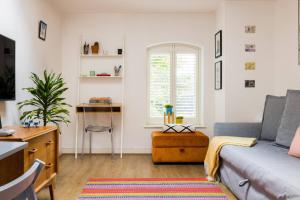 a living room with a couch and a table at Wild Roses Serviced Apartments - City Airport in North Woolwich