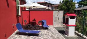 two blue chairs and an umbrella on a patio at Rondine di Mare in Fiumaretta di Ameglia